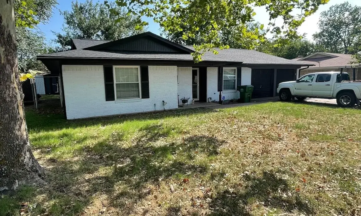 Professional roofing crew working on a residential roof in Chelsea